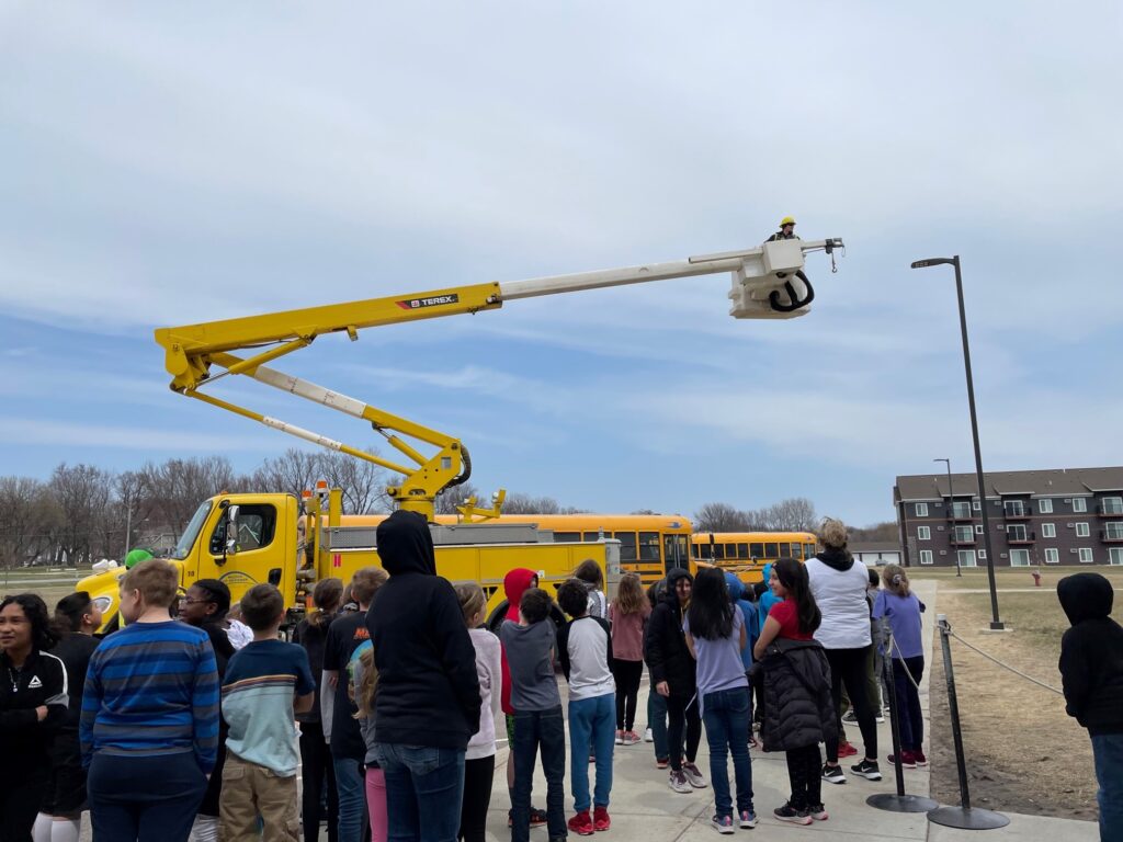 MCPA employee demonstrating a bucket aerial lift at a local school