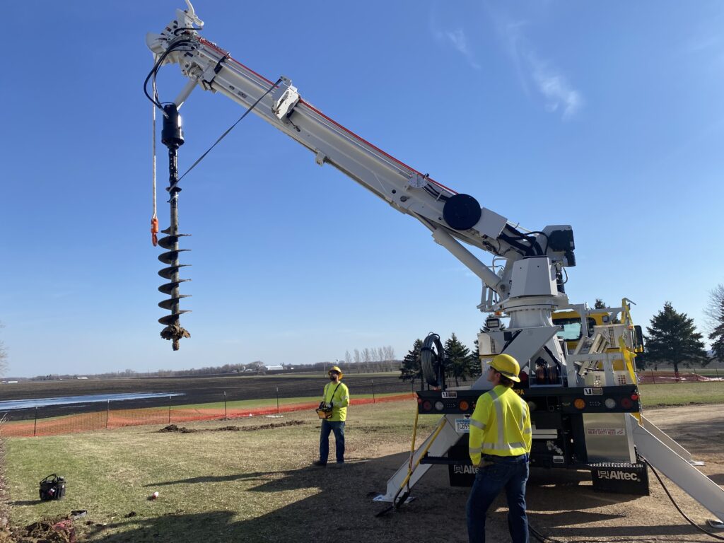 MCPA crews using its digger truck to install a new pole